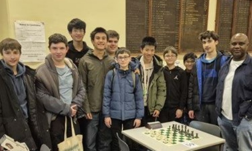 Latymer Chess team posing, along with the teacher supervising the club